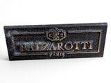 a close up of a plaque on a white surface
