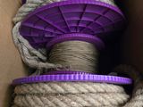 une boîte contenant une bobine de corde et une bobine violette