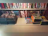 a book shelf with many books on it in a room