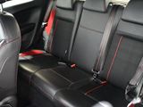 two seats in the back of a car that are black and red