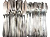 a lot of forks and spoons sitting on a table