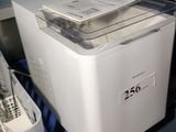 a white machine sitting on top of a counter next to other appliances