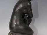 a bronze statue of a woman kneeling on her knees
