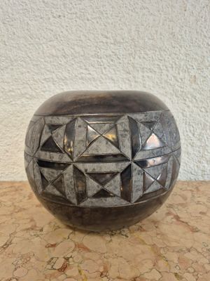 a black vase sitting on top of a table