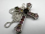 sterling silver cross with multi colored stones on a chain