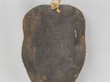 an image of a piece of wood with a gold ring on it