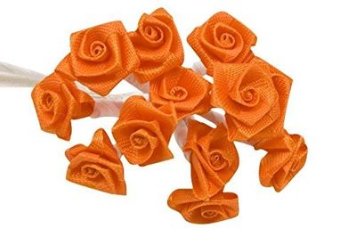 a bunch of orange roses that are on a white table
