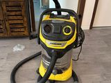 un aspirateur jaune et noir posé sur un parquet