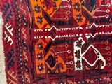 a person standing next to a rug on the floor