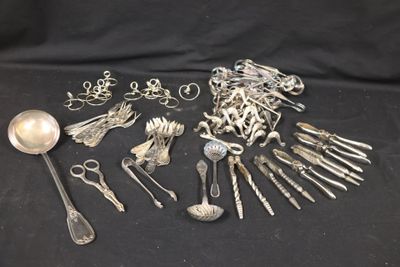 a lot of silver spoons and spoons on a black background