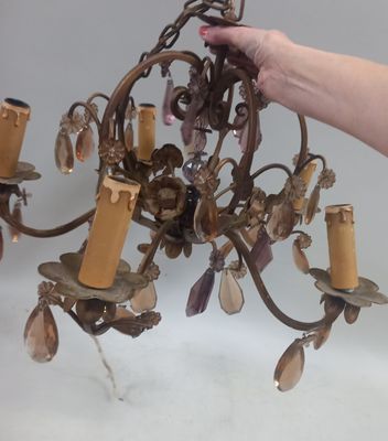 a person that is holding a chandelier in their hand