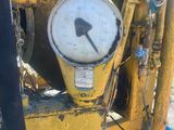 a yellow machine that is sitting on the side of the road