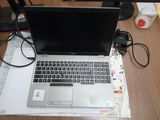 a laptop computer sitting on top of a desk next to a monitor