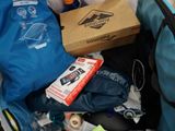 a blue bag full of stuff sitting in the back of a car