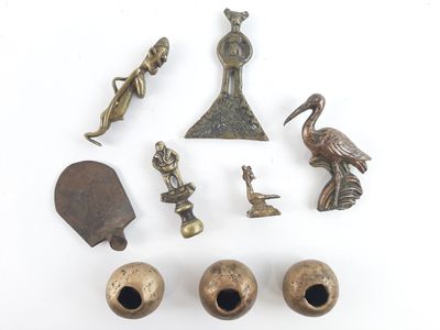 an image of a collection of bronze objects on a white surface