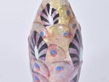 a vase that is sitting on a white surface