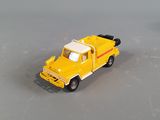 a yellow toy truck that is sitting on a table