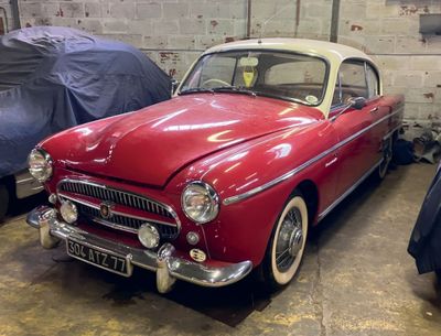 a red and white car parked in a garage