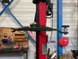 a picture of a red and black machine in a garage