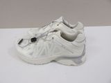 white sneakers with zippers on the side of them on a white surface