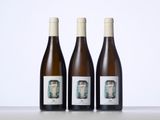 three bottles of wine sitting on top of a table