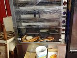 boxes of food are stacked on the floor in front of an oven