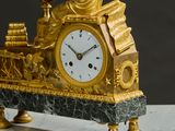 a gold clock with a woman holding a globe on top of it