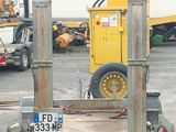 a truck with a trailer attached to it in a parking lot