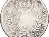 a silver coin with a crown on top of it