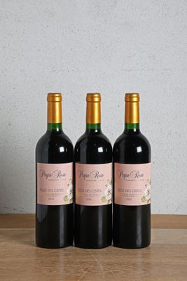 three bottles of wine sitting on top of a wooden table