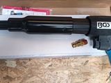 a box that has a gun in it on a table