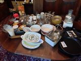 a table with a lot of dishes and bowls on it