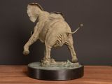 a statue of an elephant that is standing on a table