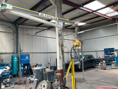 an image of a garage with a crane in the middle of it