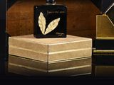 a bottle of perfume sitting on top of a wooden box
