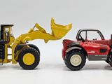a toy tractor and a toy bulldozer on a white surface