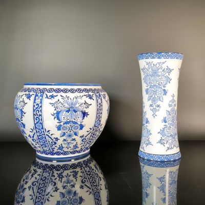 two blue and white vases sitting next to each other