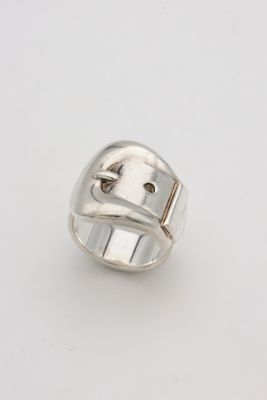 a close up of a silver ring on a white surface