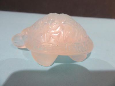 a plastic turtle that is sitting on a table