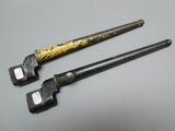 two old hammers sitting on top of a table next to each other
