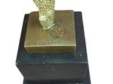 statue of an owl on a black base with a gold base