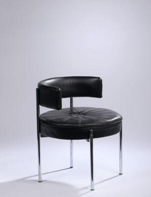 a black leather chair with chrome legs and a round seat