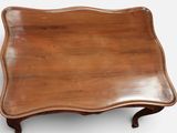 an antique wooden tray with a curved edge on a white background