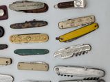 many different types of pocket knives on the table