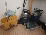 a mop, bucket, bucket, and mop holder in the corner of a room