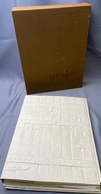 an open book sitting on top of a table next to a box