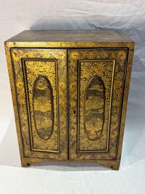 an old wooden cabinet with two doors and a door handle