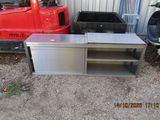 a metal table that is next to a red truck