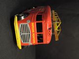 a toy fire truck that is sitting on a black surface