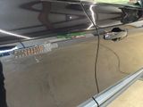 a black car with a sticker on the side of it